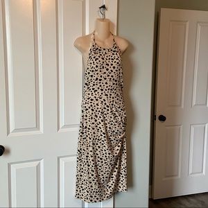 Animal print dress, ruched on the side, ties around the neck.